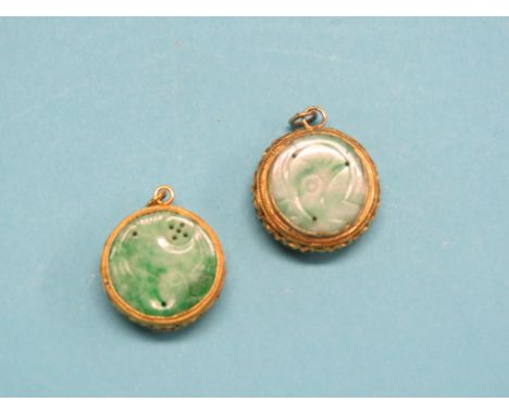 A pair of Chinese yellow metal and jade pendants, each circular, double-sided jade with incised detail