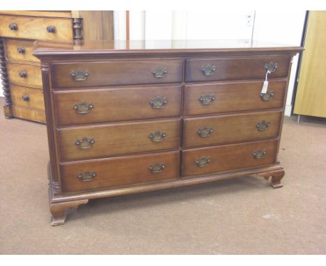 A large mahogany bedroom chest, eight drawers side-by-side, pierced brass handles, fluted quarter-columns , on ogee bracket f