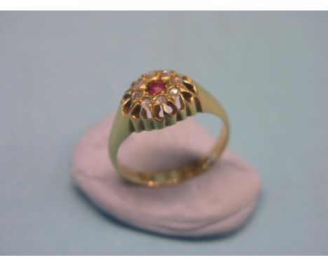 An 18ct. gold ring, set ruby and diamond chips, size L/M