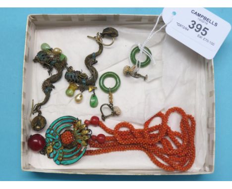 A pair of Chinese jade and seed-pearl ear-drops, a pair of Chinese white metal filigree and enamel ear-drops in the form of d