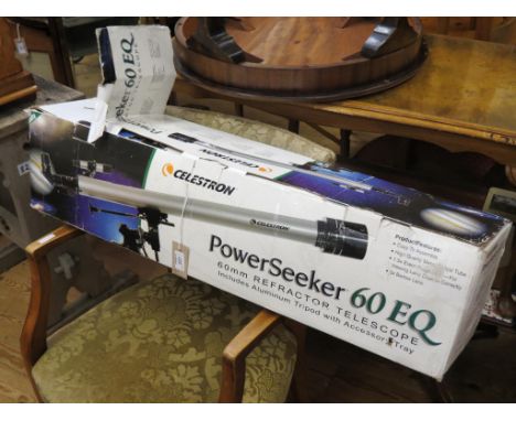 A Celestron Powerseeker 60 EQ refractor telescope, on aluminium tripod, boxed, together with a Canon T70 camera with Tamron t