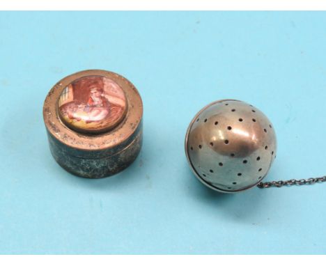 A circular silver patch box, cover with inset painted ceramic miniature, London 1907, and a silver tea infuser 