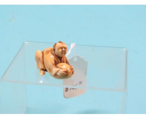 An ivory netsuke, street trader holding rice sack, unsigned, 1.75in. long  Shipping arrangements limited.  Buyer beware  