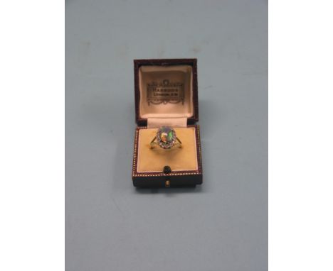 An 18ct. gold black opal and diamond chip ring, cabachon opal and old-cut diamonds, size O/P, in Harrods leather box