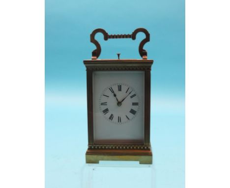 An early 20th century French brass hour-repeating carriage clock, with enamelled dial, movement striking on a gong, in archit