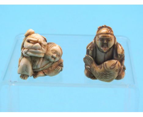 Two ivory netsuke, each a seated robed character, one holding dragon mask, the other holding large fish, latter signed, 1.5in