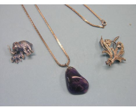 A .935 silver and enamel elephant brooch, set marcasites, a silver and macasite flower brooch, and a Blue John pendant on sil
