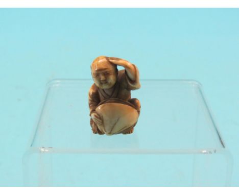 An ivory netsuke, street trader seated with large clam, signed, 1.5in.  Shipping arrangements limited.  Buyer beware   SEE IL