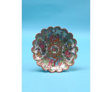 A 19th century Canton enamel dessert dish, circular with scalloped rim, painted with figures, birds and foliage in bright ena