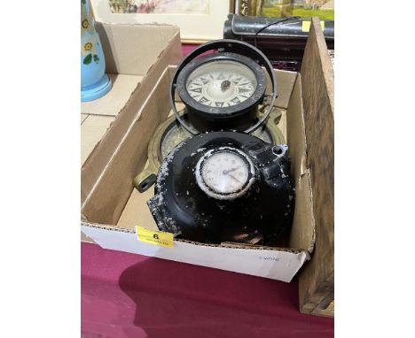 A marine gimbal compass, brass porthole with bullet hole and an aeronautical clock