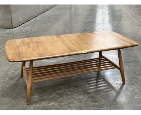 An Ercol coffee table on splayed legs united by a rack. 41' long 