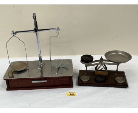 Two sets of weighing scales with weights, the larger. 11½' wide 