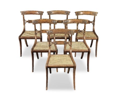 A set of six Regency simulated rosewood, brass mounted and inlaid dining chairs by John GeeCirca 1815, each with a curved and