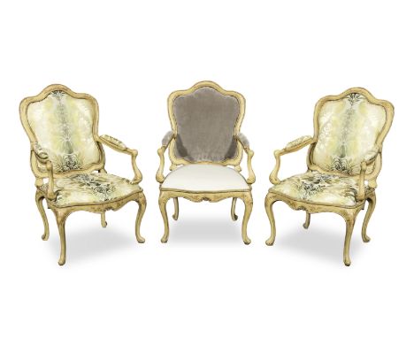 A set of three Italian 18th century painted and parcel gilt armchairs or fauteuilsProbably VenetianEach decorated with scroll