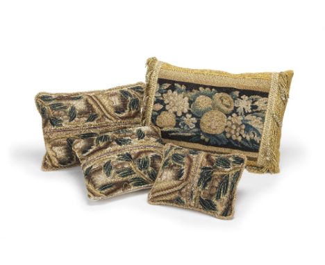 A set of four 17th/18th century needlework and tapestry fragment cushionsthree with similar fragment panels, largest 35 x 25c