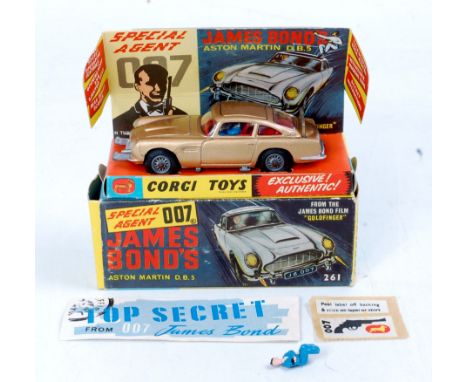 Corgi Toys, 261 James Bond's Aston martin DB5, gold body, red interior with wire wheels, 2 bandit figures, mechanism in worki