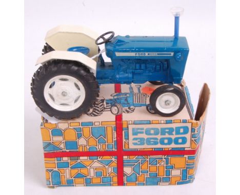 A Maxwell Company of Calcutta diecast model of a Ford  3600 tractor finished in blue and white with white hubs in the origina
