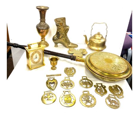 Selection of assorted brass ware includes warming pan, a boot, clock etc 