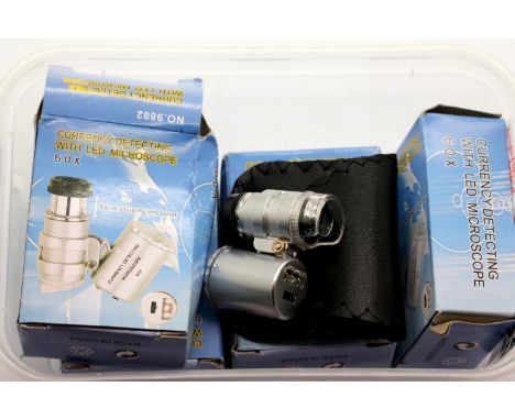 Four boxed 60x jewellers loupes with LED light and leather case. Not available for in-house P&amp;P 