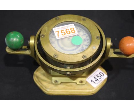 Brass bound nautical gimbal compass, mounted on a light oak plinth, W: 23 cm. P&amp;P Group 3 (£25+VAT for the first lot and 