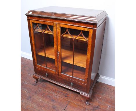 An early 20th century burr walnut veneered display cabinet, with bead &amp; reel moulded caddy top above a pair of lattice gl