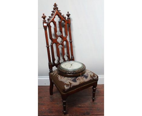 A Victorian stained oak nursing with pierced gothic tracery back and tapestry seat, together with a circualr aneroid baromete