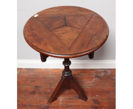 A small Gothic revival oak table in the style of Augustus Pugin, the circular top above a tripartite frieze with single drawe