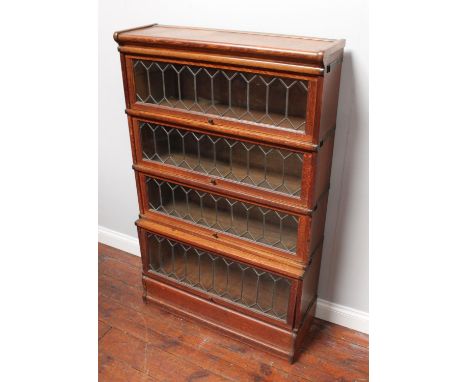 An oak four-section Globe Wernicke bookcase, two sections with 'Globe Wernicke' labels and two with 'Ebenezer Smith' labels, 