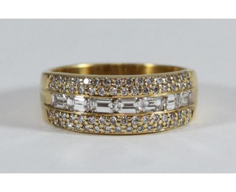 An 18ct gold three row ring, channel-set with seven baguette diamonds to the centre and pave-set with 66 round brilliant-cut 