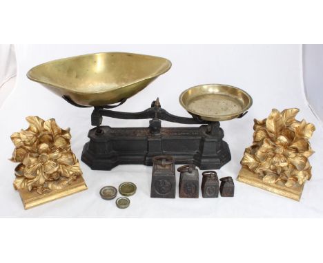 A set of cast metal scales with brass trays and weights, together with a pair of gold painted, composite wall brackets 