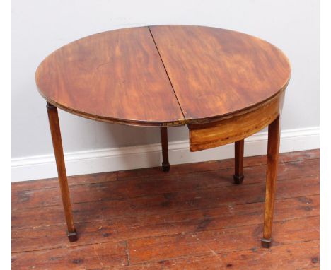 A George III mahogany and cross-banded demi-lune folding tea table with gate-leg square tapering supports to spade feet, 92cm