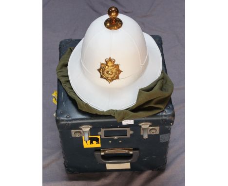 A Royal Marines white Pith Helmet with gilt finial, helmet plate and chin-chain, with green canvas sack and 'stores' hard sto