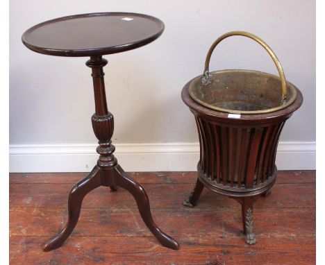 An early 20th century brass peat bucket with stained wood spindle stand, together with a stained walnut circular tripod table