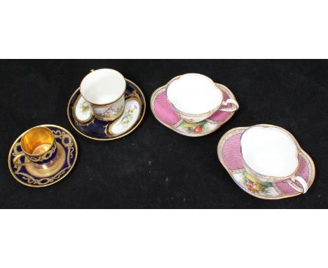 A pair of Meissen porcelain cabinet cups and saucers of quarter-foil shape and painted with courting scenes to the reserves, 