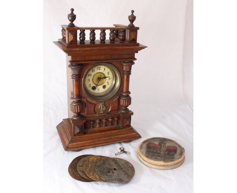 An early 20th century German Symphonion mantel Clock, together with 11x Junghans steel discs, playing on the hours, in walnut