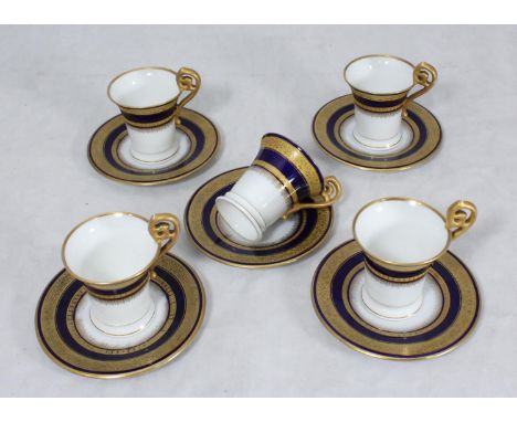 SECTION 31. A set of five Vienna coffee cups and saucers, decorated in a blue and gilt design 