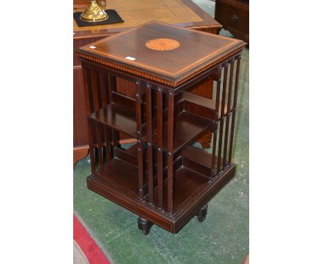 An Edwardian mahogany revolving bookcase, satinwood, boxwood and ebony inlay, ceramic castors