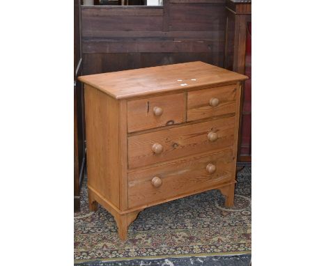 A pine chest, oversailing top, two short drawers over two long, button handles