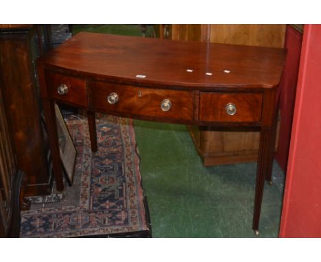 A Regency  bow fronted side table, oversailing top, one long drawer flanked by two short, reeded tapering square supports, br