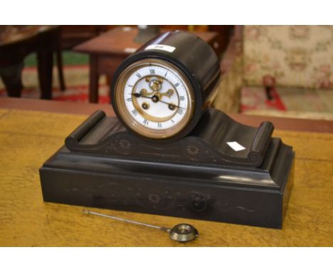 A Victorian slate drum case mantle clock, enamel dial, Roman numerals, visible escapement.