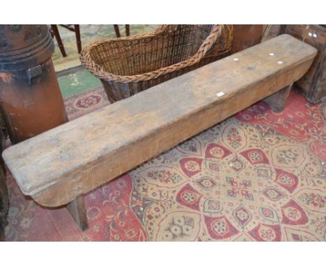 A rustic pine bench, 41cm high, 183cm long, 27cm wide