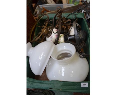 An ornate French chandelier type oil lamp with white glass shade converted to electricity; two others with white glass shades