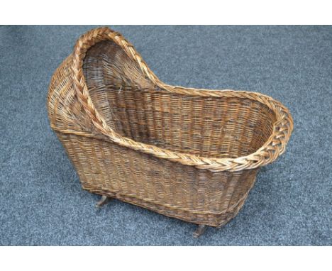 A vintage rocking wicker cot