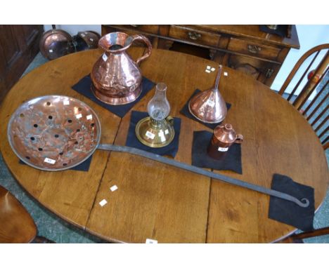 A large copper hops pan, a copper flagon, copper funnel, a brass oil lamp, copper canister, qty