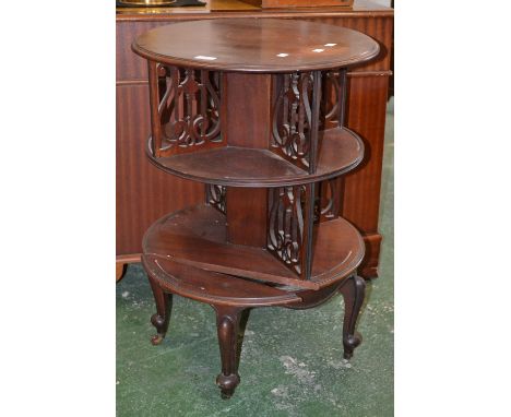 An Edwardian mahogany three tier circular centre whatnot, moulded top, each tier divided into four sections with fret worked 