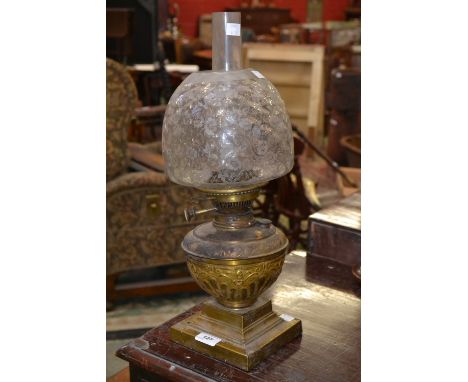 A Victorian brass oil lamp, etched glass shade, stepped base
