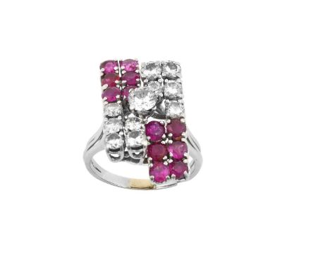 A Ruby and Diamond Cluster Ringa raised round brilliant cut diamond, to a geometric motif, formed of round brilliant cut diam