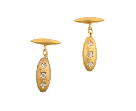 A Pair of Diamond Cufflinksthe yellow domed oval plaque inset with three old cut diamonds, chain linked to a torpedo shaped b