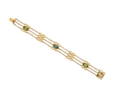 An Early 20th Century Peridot, Green Tourmaline and Seed Pearl Braceletthree yellow trace link chains interspaced by scroll l