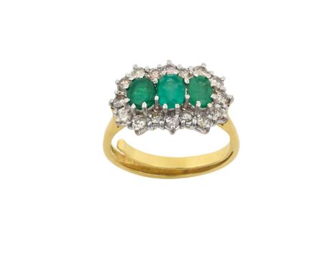 An 18 Carat Gold Emerald and Diamond Triple Cluster Ringthree graduated oval cut emeralds within a border of round brilliant 